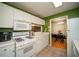 Cozy kitchen features white appliances, countertops, and cabinets and leads into the dining area at 1207 Summit North Ne Dr # 1207, Atlanta, GA 30324