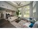 Bright living room with large windows, a ceiling fan, hardwood floors, and an open floor plan into the kitchen at 1207 Summit North Ne Dr # 1207, Atlanta, GA 30324
