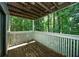 Outdoor patio area with wooden flooring and railings, offering scenic views of the surrounding trees at 1207 Summit North Ne Dr # 1207, Atlanta, GA 30324