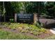 Piedmont Heights Condominiums sign surrounded by colorful flowers and lush greenery at 1207 Summit North Ne Dr # 1207, Atlanta, GA 30324