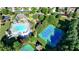 Aerial image featuring community amenities, including a pool, tennis courts, and a playground at 1891 Primrose Park Rd, Sugar Hill, GA 30518