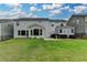 Large backyard featuring a storage shed, patio, landscaping, and well manicured lawn at 1891 Primrose Park Rd, Sugar Hill, GA 30518