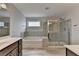Well-lit bathroom featuring a separate soaking tub and glass-enclosed shower at 1891 Primrose Park Rd, Sugar Hill, GA 30518