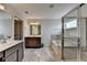 Bathroom featuring dual sink vanities, a soaking tub and glass shower at 1891 Primrose Park Rd, Sugar Hill, GA 30518