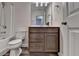 Bathroom boasts a toilet, vanity, mirror, and a shower-tub combination at 1891 Primrose Park Rd, Sugar Hill, GA 30518