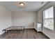 Bedroom featuring white walls, wood floors, and a window with blinds at 1891 Primrose Park Rd, Sugar Hill, GA 30518