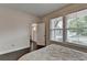 Cozy bedroom with hardwood floors, large windows, and view to entryway at 1891 Primrose Park Rd, Sugar Hill, GA 30518