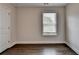 Bedroom showcases hardwood floors, a window with blinds, and neutral paint at 1891 Primrose Park Rd, Sugar Hill, GA 30518