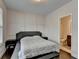 Calming bedroom with paneled accent wall, neutral colors, and an attached bathroom at 1891 Primrose Park Rd, Sugar Hill, GA 30518