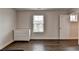 Bedroom featuring a white dresser, wood floors, and a window with blinds at 1891 Primrose Park Rd, Sugar Hill, GA 30518