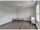Bedroom featuring white walls, wood floors, and a large window with blinds at 1891 Primrose Park Rd, Sugar Hill, GA 30518
