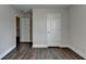 Bedroom features dark wood floors, neutral walls, and an open doorway to the rest of the home at 1891 Primrose Park Rd, Sugar Hill, GA 30518