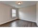 Bedroom features hardwood floors, a window with blinds, and neutral paint at 1891 Primrose Park Rd, Sugar Hill, GA 30518