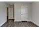 Bedroom displays hardwood floors and two white interior doors at 1891 Primrose Park Rd, Sugar Hill, GA 30518