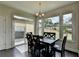 Dining room featuring a black table and chairs, and large windows to the backyard at 1891 Primrose Park Rd, Sugar Hill, GA 30518