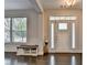 Elegant entryway featuring dark hardwood floors, transom windows, and bright white trim at 1891 Primrose Park Rd, Sugar Hill, GA 30518