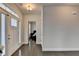 Bright entryway featuring hardwood floors, transom windows, and a view into a bedroom at 1891 Primrose Park Rd, Sugar Hill, GA 30518
