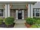 Welcoming front entrance with a black door, sidelights, brick accents, and well-maintained landscaping at 1891 Primrose Park Rd, Sugar Hill, GA 30518