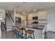Spacious kitchen with a large island, stainless steel appliances, and access to a staircase at 1891 Primrose Park Rd, Sugar Hill, GA 30518
