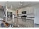 Spacious kitchen featuring a large granite island with seating, stainless steel appliances, and pendant lighting at 1891 Primrose Park Rd, Sugar Hill, GA 30518