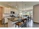 Bright kitchen features a large island, granite countertops, and modern pendant lighting at 1891 Primrose Park Rd, Sugar Hill, GA 30518
