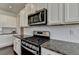Modern kitchen features stainless steel appliances, granite countertops, and white subway tile backsplash at 1891 Primrose Park Rd, Sugar Hill, GA 30518
