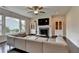 Spacious living room with hardwood floors, fireplace, and natural lighting at 1891 Primrose Park Rd, Sugar Hill, GA 30518