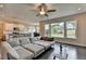 Bright, open living space features large windows and flows into a modern kitchen with a large island at 1891 Primrose Park Rd, Sugar Hill, GA 30518