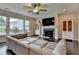 Spacious living room with large windows, hardwood floors, and fireplace at 1891 Primrose Park Rd, Sugar Hill, GA 30518