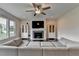 Open living room with fireplace and hardwood floors at 1891 Primrose Park Rd, Sugar Hill, GA 30518