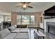 Cozy living room with a fireplace, modern decor, and a view to the backyard at 1891 Primrose Park Rd, Sugar Hill, GA 30518