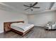Main bedroom features a bed, hardwood floors, and a ceiling fan at 1891 Primrose Park Rd, Sugar Hill, GA 30518