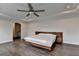 Main bedroom features hardwood floors, a ceiling fan, and a bed at 1891 Primrose Park Rd, Sugar Hill, GA 30518
