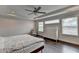 Main bedroom boasts hardwood floors, a ceiling fan, a bed, and a dresser at 1891 Primrose Park Rd, Sugar Hill, GA 30518