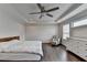 Main bedroom showcases hardwood floors, a ceiling fan, a bed, and a dresser at 1891 Primrose Park Rd, Sugar Hill, GA 30518