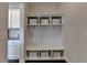 Mudroom with built-in storage, cubbies, hooks, and bench, connecting the kitchen to the entrance at 1891 Primrose Park Rd, Sugar Hill, GA 30518