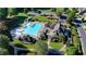 Aerial view of the community pool with a slide, umbrellas, and seating for residents to enjoy at 1891 Primrose Park Rd, Sugar Hill, GA 30518