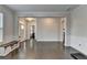 Open room with hardwood floors, white trim, and natural light from windows and entrance at 1891 Primrose Park Rd, Sugar Hill, GA 30518