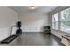 Versatile room with dark wood floors, crown molding, wainscoting, and bright natural light at 1891 Primrose Park Rd, Sugar Hill, GA 30518