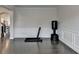 Room with hardwood floors, crown molding, wainscoting, fitness equipment and bright natural light at 1891 Primrose Park Rd, Sugar Hill, GA 30518