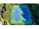Overhead view of the community tennis courts, surrounded by mature trees and greenery at 1891 Primrose Park Rd, Sugar Hill, GA 30518