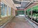Screened in back porch with brick exterior and views of the trees at 20 Shadow Creek Dr, Villa Rica, GA 30180