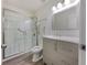 Modern bathroom with a glass-enclosed shower, sleek vanity, and accessible features at 20 Shadow Creek Dr, Villa Rica, GA 30180