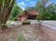 Charming brick home featuring a convenient drive-through carport and lush, mature landscaping at 20 Shadow Creek Dr, Villa Rica, GA 30180