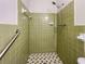 Shower featuring unique green tile surround, shower head, and patterned tile flooring at 20 Shadow Creek Dr, Villa Rica, GA 30180