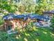 Aerial view of a fenced backyard featuring a brick home with a patio dining set and a well-maintained lawn at 2648 Oswood Dr, Tucker, GA 30084
