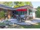 A tranquil patio setting with furniture and a red umbrella for relaxing outdoor entertainment at 2648 Oswood Dr, Tucker, GA 30084