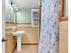 Charming bathroom with tiled walls, pedestal sink, and classic design at 2648 Oswood Dr, Tucker, GA 30084
