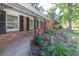 Welcoming front porch with decorative iron posts surrounded by lush flowerbeds with colorful roses at 2648 Oswood Dr, Tucker, GA 30084