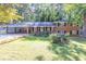 Charming brick home with a well-manicured lawn and colorful flowerbeds in a peaceful, wooded setting at 2648 Oswood Dr, Tucker, GA 30084
